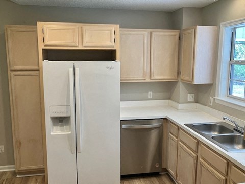 a kitchen with a refrigerator and a sink