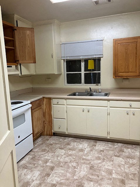 A kitchen with a white dishwasher and a sink.