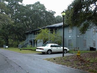 a white car parked in front of a building