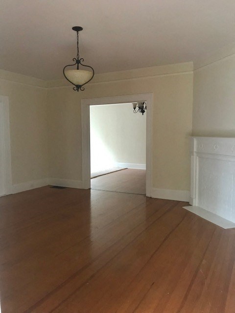 an empty living room with a hard wood floor