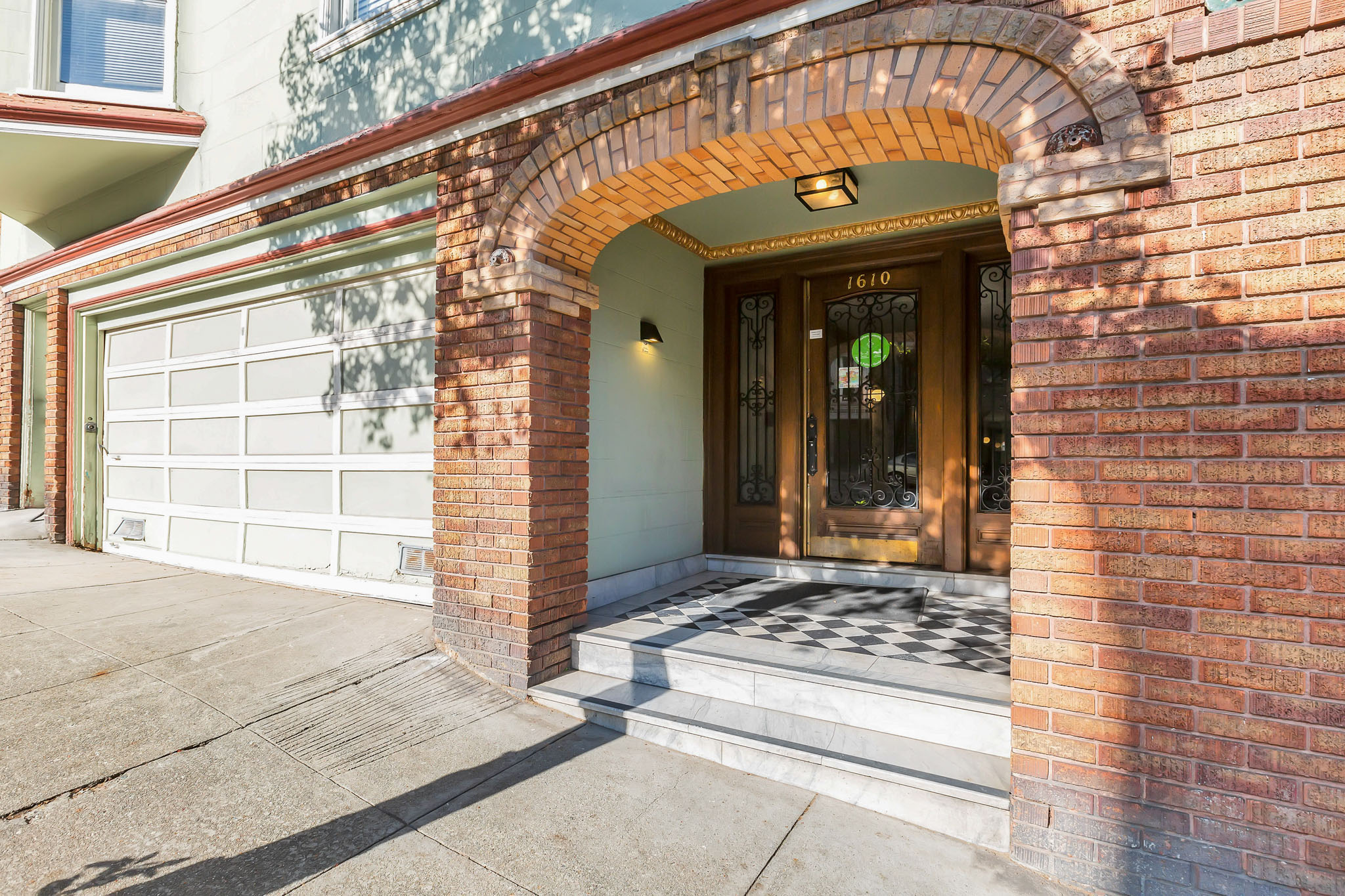 A house with a brown archway and a glass door.