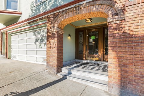 A house with a brown archway and a glass door.