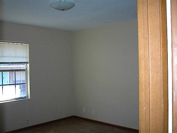 A room with a window and a ceiling light.