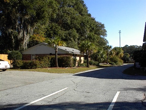 A white car is parked on the left side of the street.