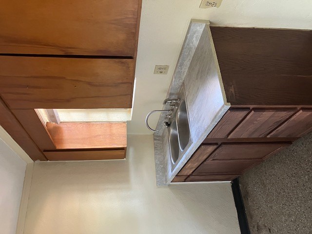a kitchen with a sink and wooden cabinets