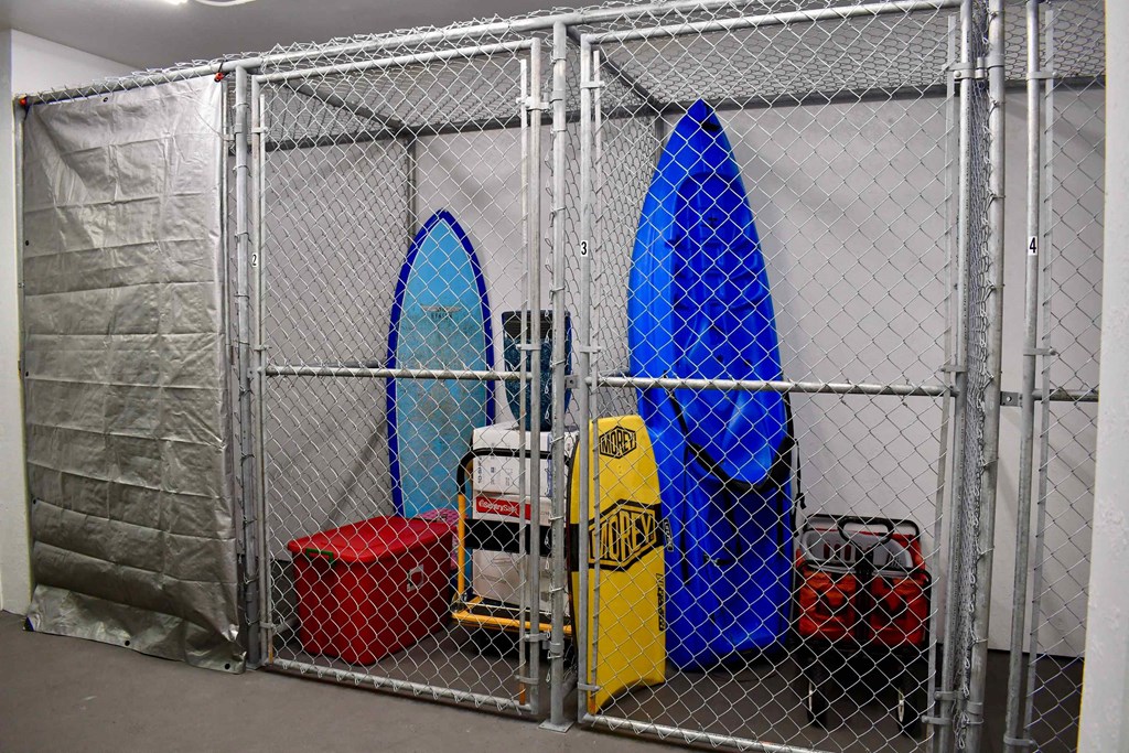a group of surfboards in a metal fence