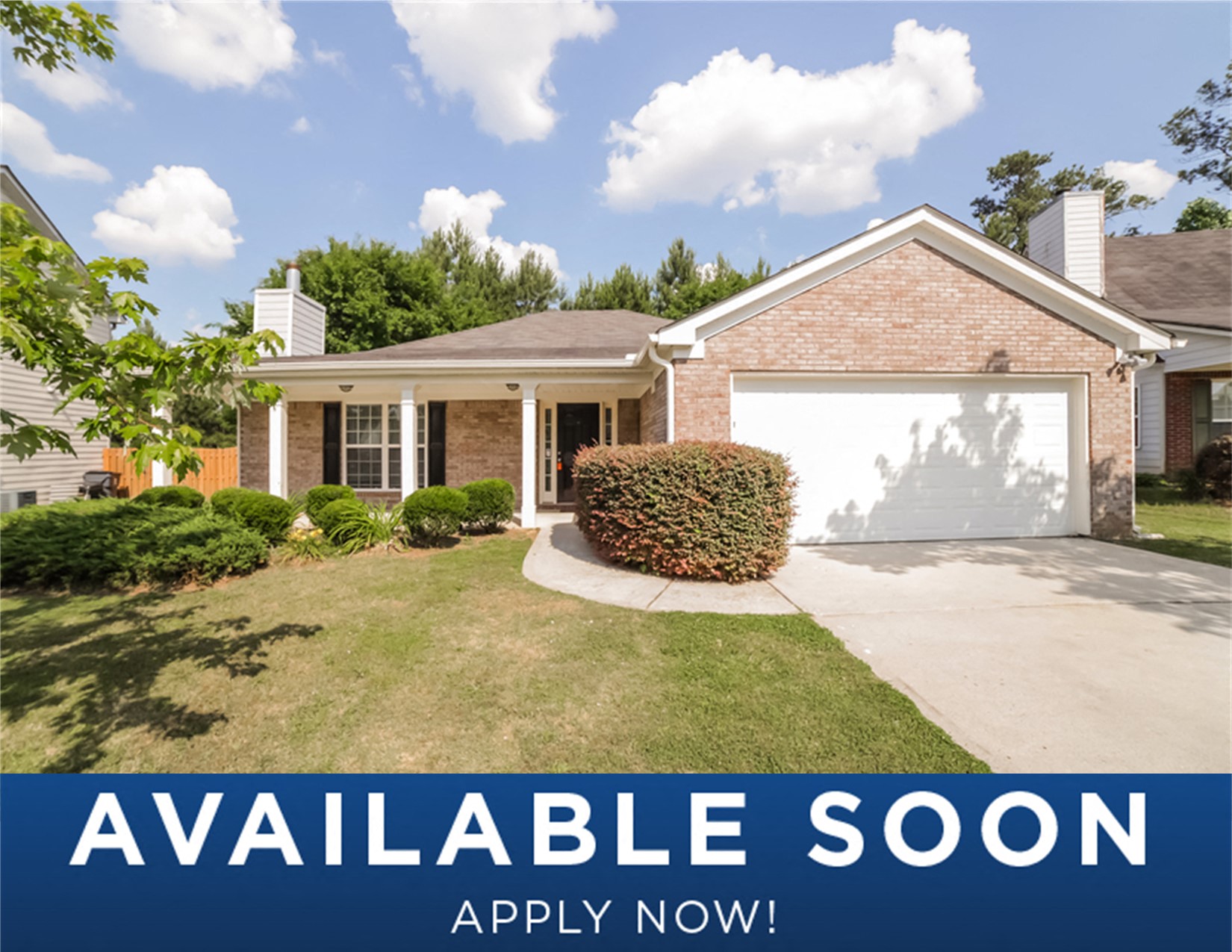 a house with a garage door and a lawn