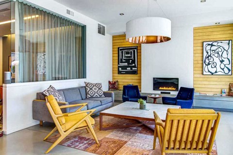 A living room with a grey couch, a blue chair, and a yellow chair.