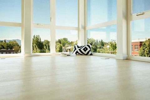 A room with a large window and a zebra rug on the floor.