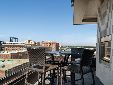 Rooftop deck with high tables at The Douglas Apartments in Denver