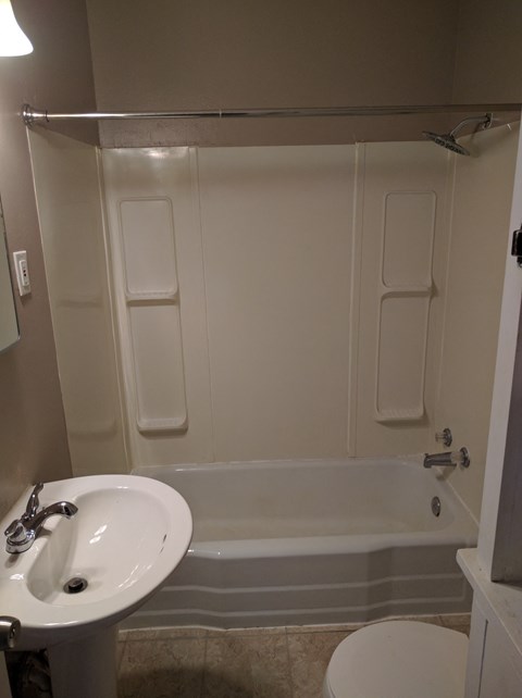 a bathroom with a sink and a tub and a toilet