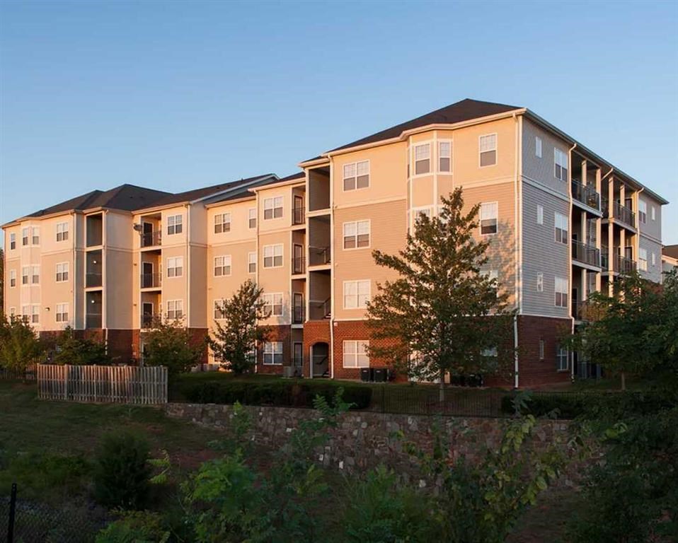 an exterior view of an apartment building at sunset
