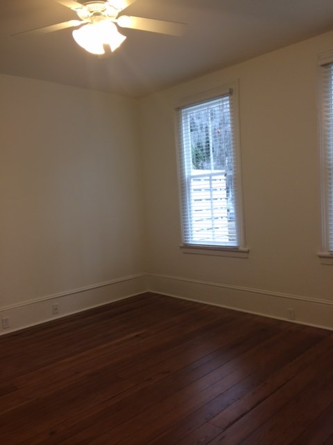 A room with a window and a ceiling fan.