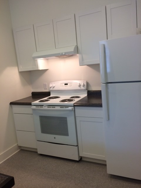 a kitchen with white appliances and white cabinets