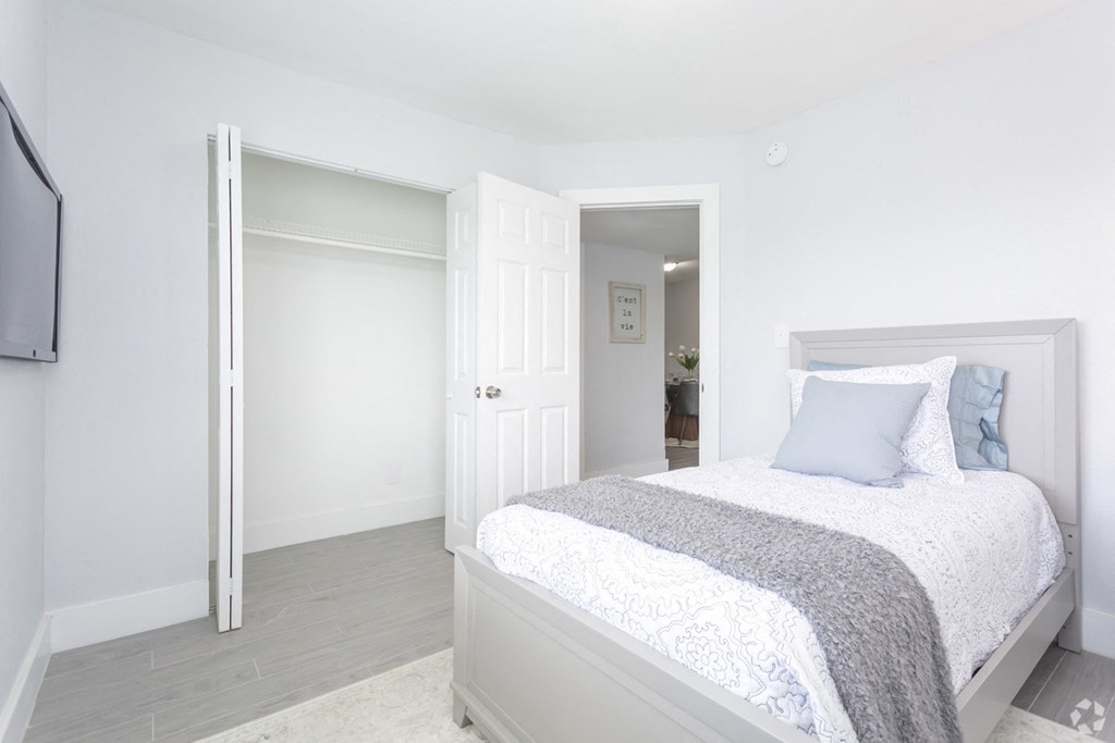 a bedroom with a bed and a door to a bathroom