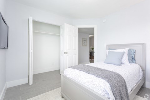 a bedroom with a bed and a door to a bathroom