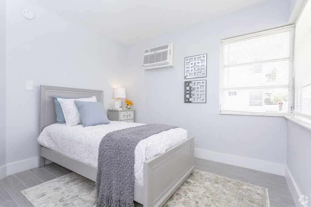 a bedroom with a bed and a window