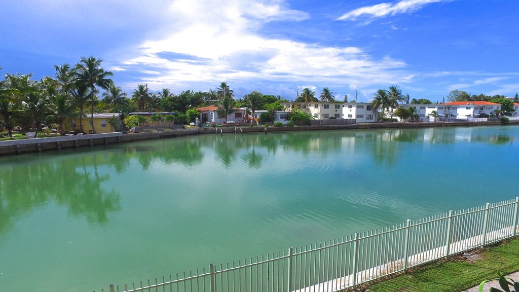 a large pool of water with houses in the background
