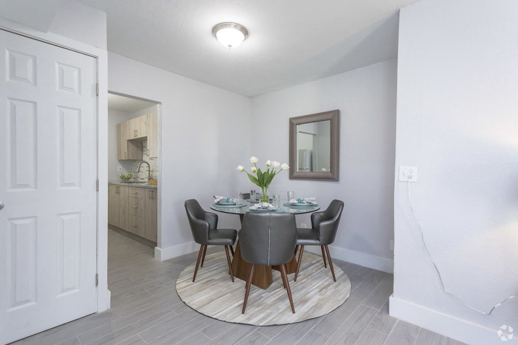 a dining room with a table and chairs