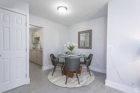 a dining room with a table and chairs