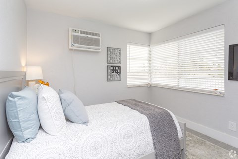 a bedroom with a large bed and a window