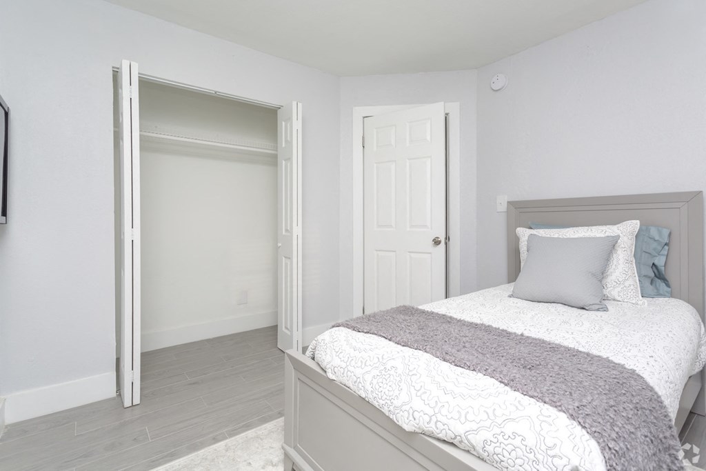 a bedroom with a bed and a closet
