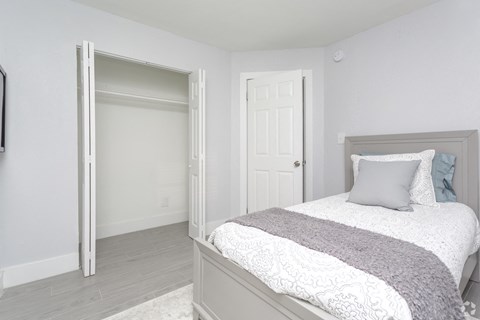 a bedroom with a bed and a closet