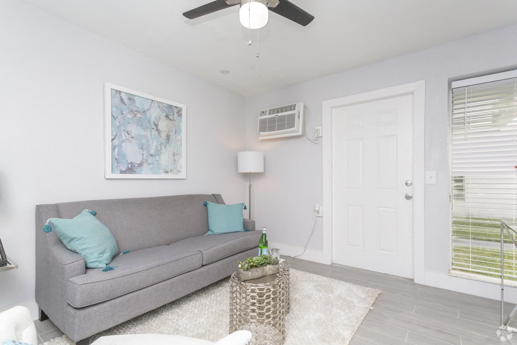 a living room with a couch and a ceiling fan