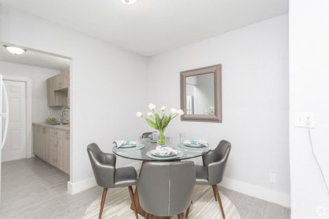 a dining room with a table and chairs