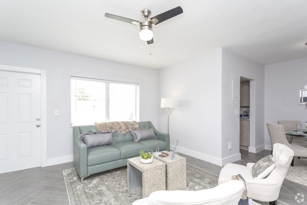 a living room with a couch and a ceiling fan