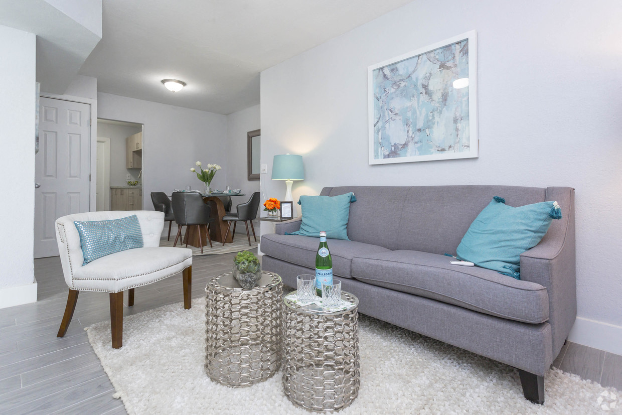 a living room with a couch and a table with two chairs