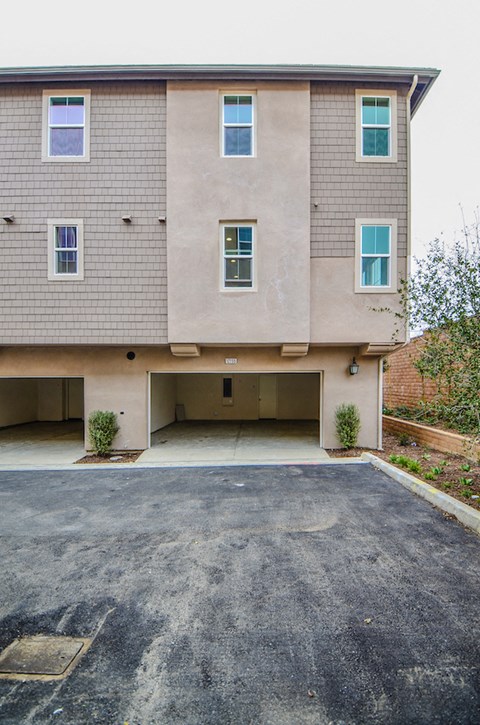 an empty parking lot in front of an apartment building