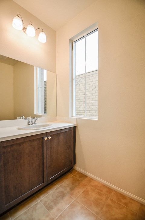 a bathroom with a sink and a window