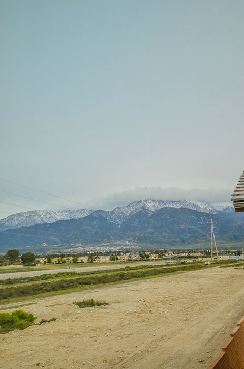 a dirt road with mountains in the background