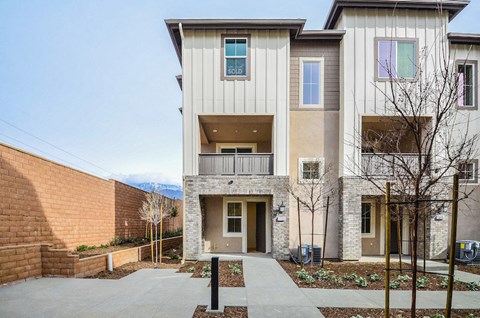 a white house with a sidewalk in front of it