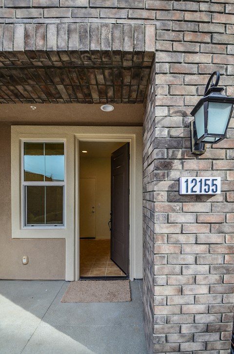 a brick building with a door and a street light