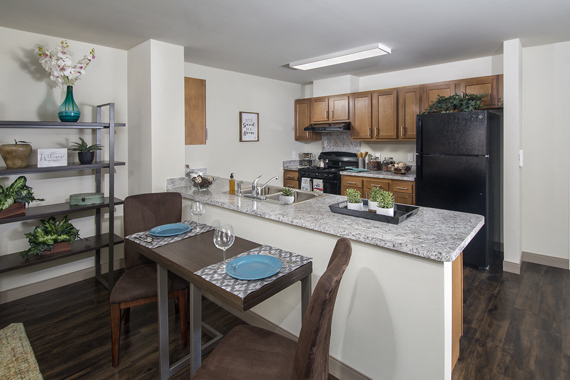 A kitchen with a table set for two.