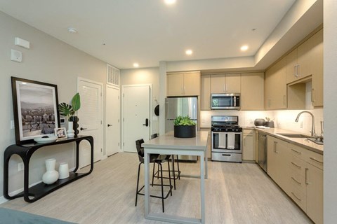 A modern kitchen with a dining table and chairs.