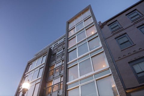 the facade of a building with windows at night