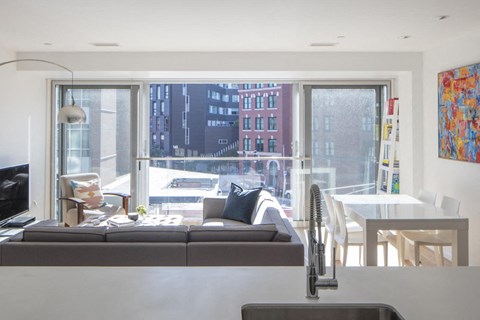 a living room with a couch in front of a large window