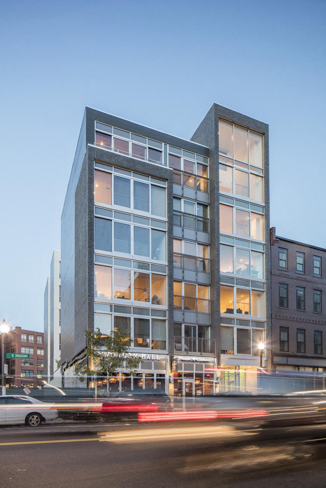 a tall building with a city street in front of it
