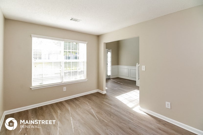 the living room and dining room of an apartment