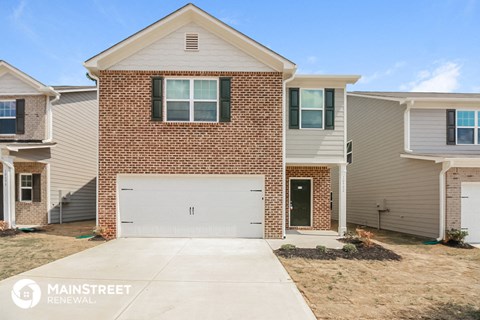 a new brick house with a white garage door