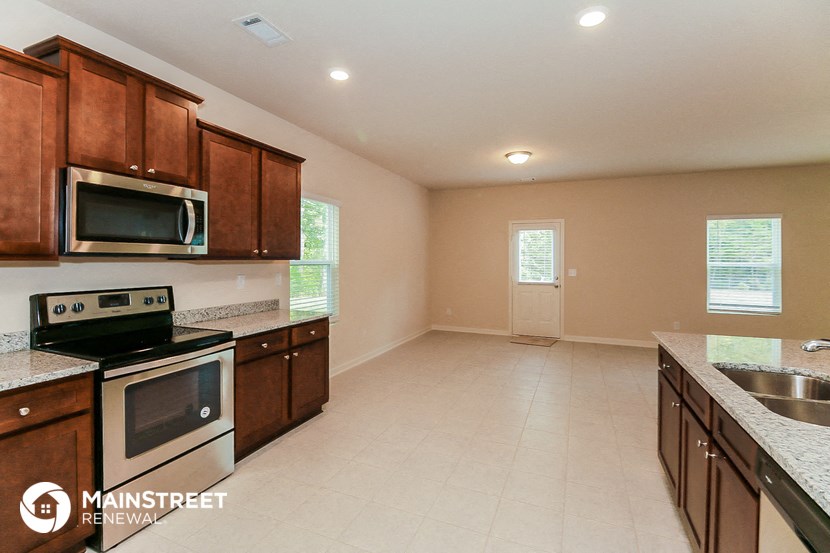 a kitchen with wooden cabinets and stainless steel appliances