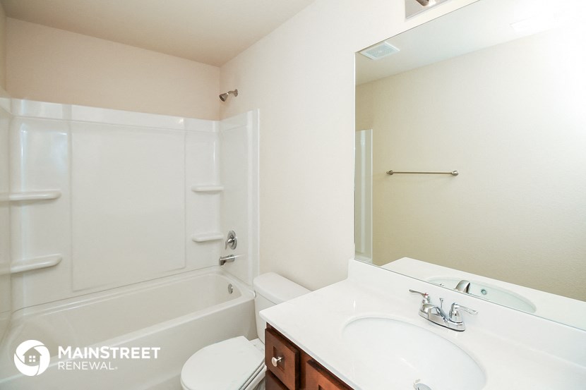 a bathroom with a sink and a toilet and a shower