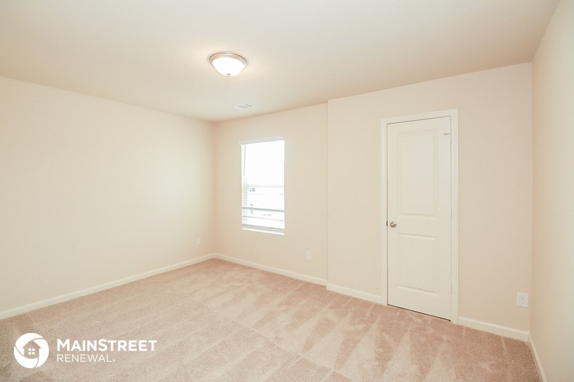 the upstairs bedroom with a door to the ensuite bathroom