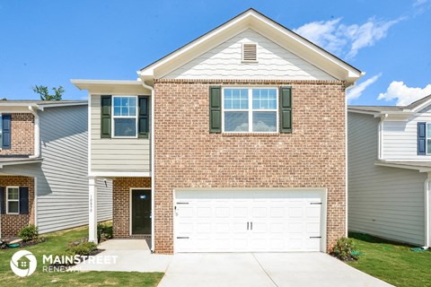 a brick house with a white garage door