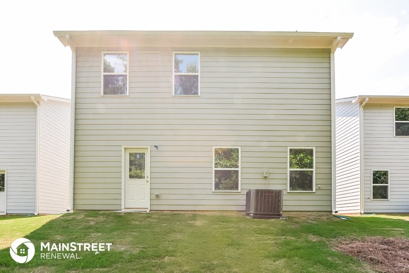 a white house with a trash can in front of it