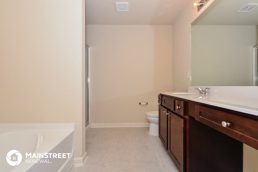 a bathroom with a sink and a toilet and a shower
