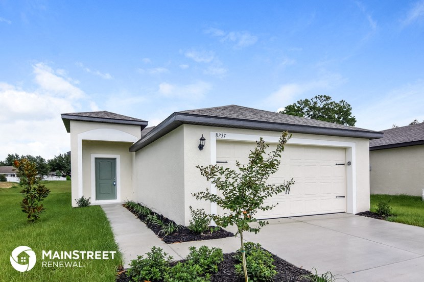 a white house with a driveway and a garage door